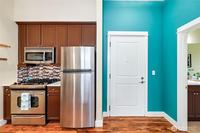 400 Washington Ave Unit 415, Bremerton, WA 98337 - kitchen with stainless steel appliances, light wood-type flooring, tasteful backsplash, and light countertops