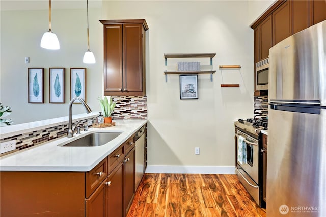 400 Washington Ave Unit 415, Bremerton, WA 98337 - kitchen featuring appliances with stainless steel finishes, a sink, tasteful backsplash, light countertops, and wood finished floors