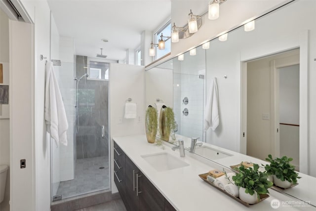 full bath featuring a stall shower, vanity, and toilet