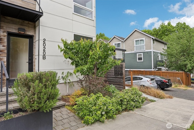 view of front of property with fence and stairs