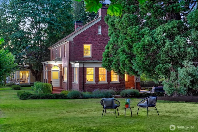 4404 Montana Cir W, Seattle, WA 98199 - rear view of house featuring brick siding, a yard, and a chimney