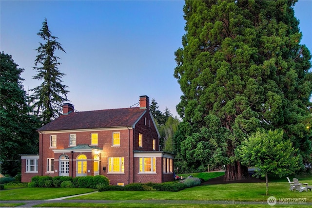4404 Montana Cir W, Seattle, WA 98199 - colonial inspired home featuring a chimney, a lawn, and brick siding