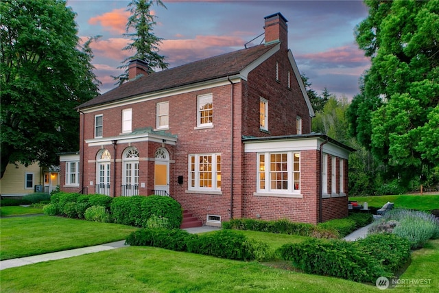4404 Montana Cir W, Seattle, WA 98199 - view of front of home with a chimney, a yard, and brick siding