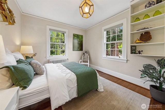 4404 Montana Cir W, Seattle, WA 98199 - bedroom with baseboards, ornamental molding, multiple windows, radiator heating unit, and wood finished floors