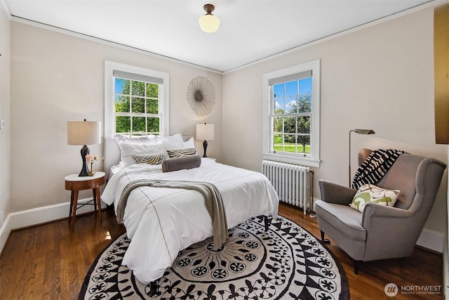 4404 Montana Cir W, Seattle, WA 98199 - bedroom featuring radiator heating unit, multiple windows, ornamental molding, baseboards, and wood finished floors
