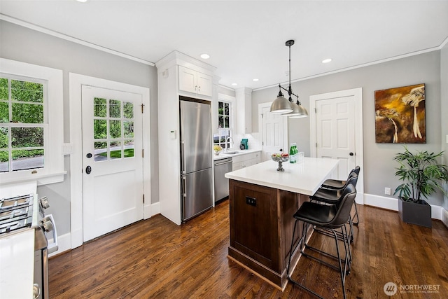 4404 Montana Cir W, Seattle, WA 98199 - kitchen with stainless steel appliances, a sink, baseboards, crown molding, and light countertops