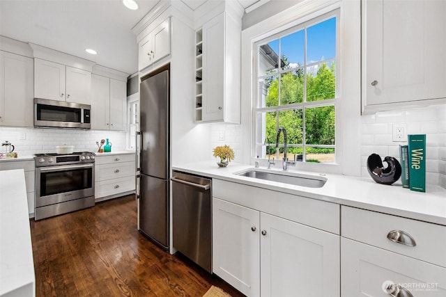 4404 Montana Cir W, Seattle, WA 98199 - kitchen featuring appliances with stainless steel finishes, a sink, light countertops, tasteful backsplash, and recessed lighting