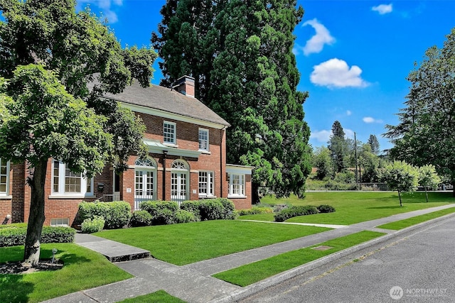 4404 Montana Cir W, Seattle, WA 98199 - colonial home featuring brick siding, a front yard, and a chimney