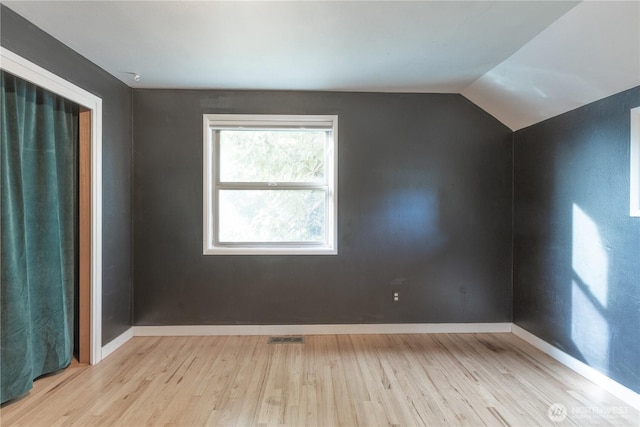 2010 13th Ave NW, Puyallup, WA 98371 - unfurnished room featuring wood finished floors, baseboards, and lofted ceiling