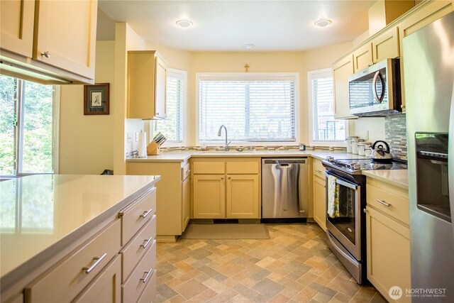 2016 Creekside Ln, Anacortes, WA 98221 - kitchen with stainless steel appliances, a sink, light countertops, and backsplash