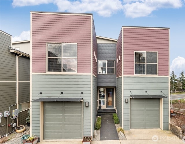 view of front of property with a garage and concrete driveway