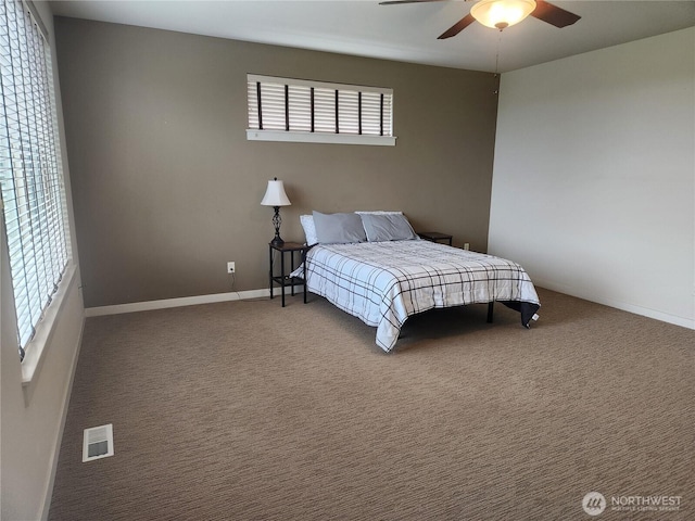 bedroom with baseboards, ceiling fan, and carpet