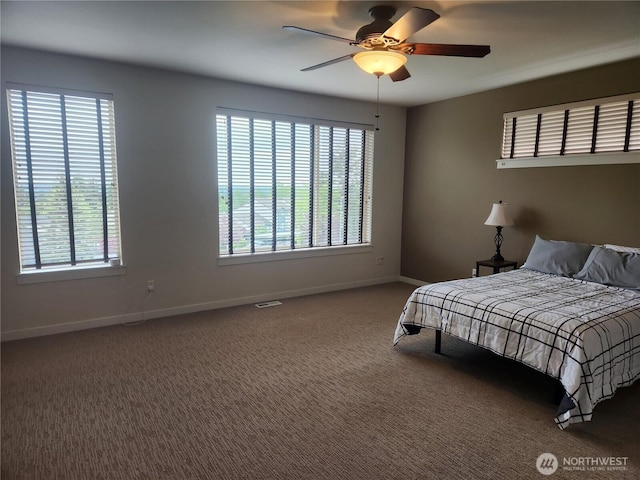 carpeted bedroom with baseboards and a ceiling fan