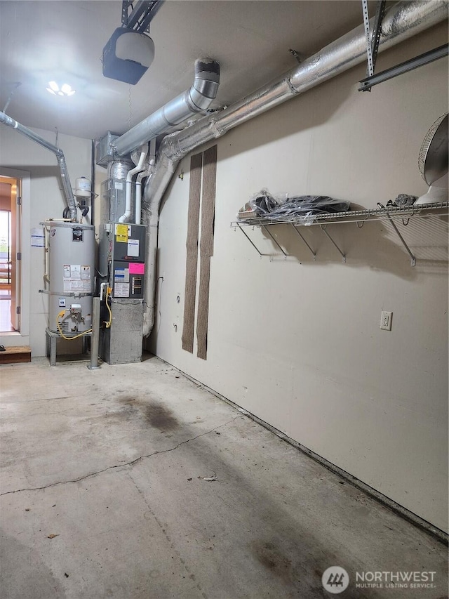 garage featuring water heater and heating unit