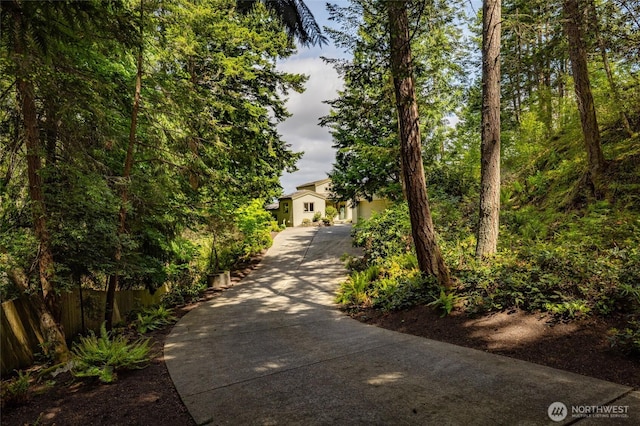 view of property hidden behind natural elements featuring fence