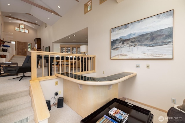 staircase with carpet flooring, high vaulted ceiling, and recessed lighting