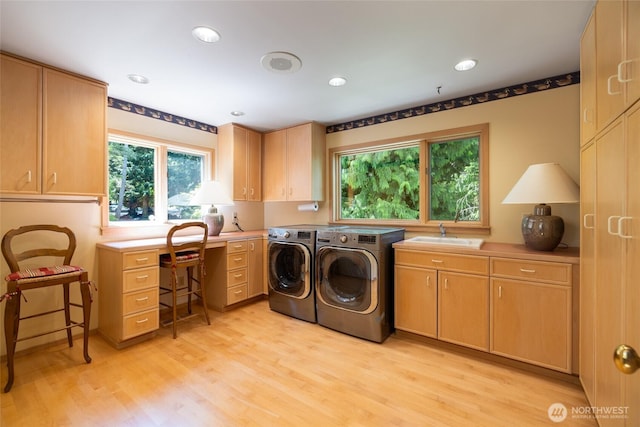 washroom with cabinet space, independent washer and dryer, light wood-style flooring, plenty of natural light, and recessed lighting