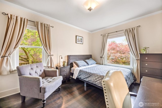 bedroom featuring wood finished floors, crown molding, and baseboards