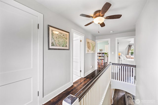 hallway with wood finished floors and baseboards