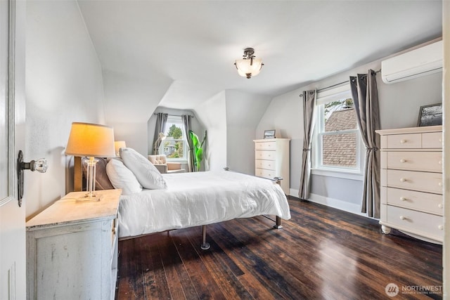 bedroom with a wall mounted air conditioner, dark wood finished floors, lofted ceiling, and baseboards