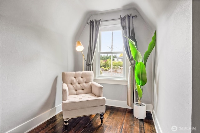 sitting room featuring wood-type flooring, lofted ceiling, and baseboards