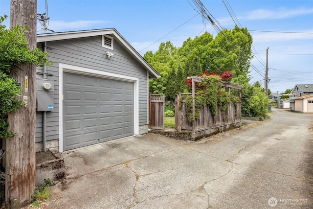 detached garage with concrete driveway