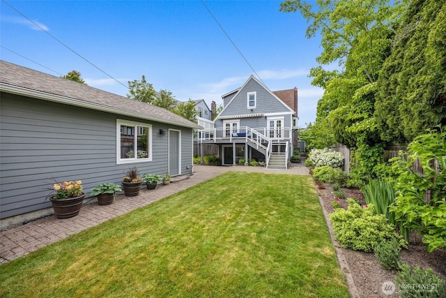 back of house featuring stairs and a deck