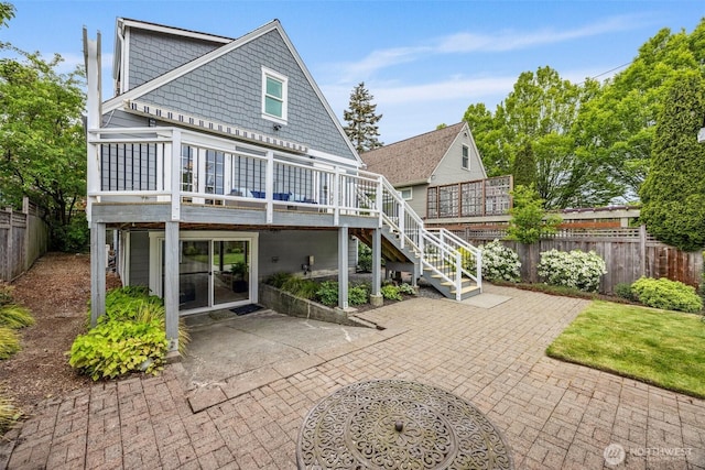 back of property with a patio, fence, a deck, and stairway