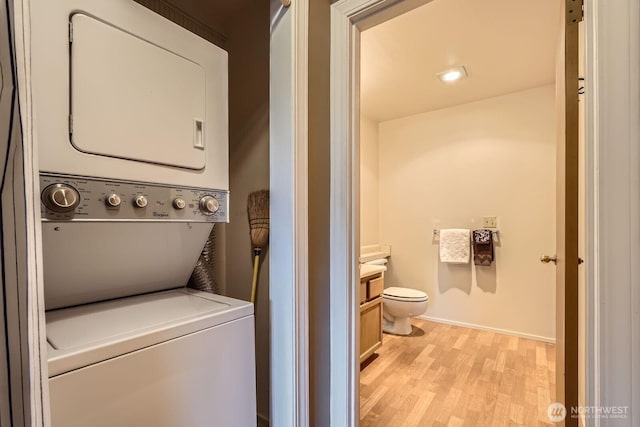 4105 Providence Point Dr SE, Issaquah, WA 98029 - laundry area with stacked washing machine and dryer, light wood-type flooring, and baseboards
