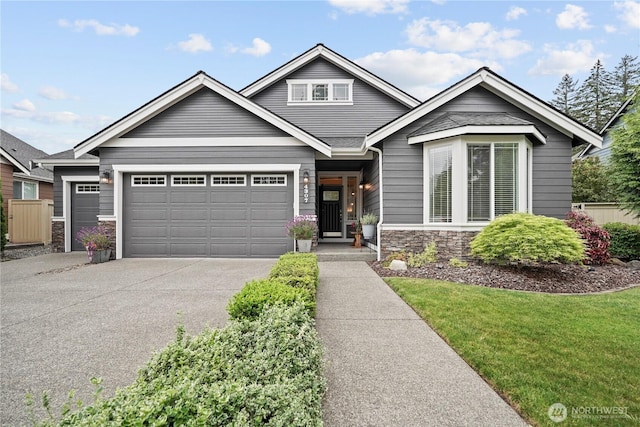 4307 Abigail Dr NE, Lacey, WA 98516 - view of front of home featuring stone siding, an attached garage, concrete driveway, and a front yard