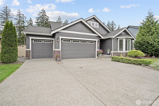 4307 Abigail Dr NE, Lacey, WA 98516 - view of front of home with a garage, driveway, stone siding, and a shingled roof