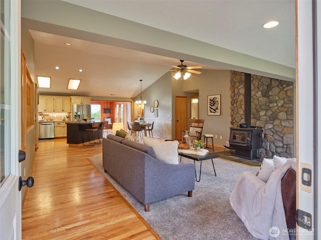 13708 401st Way, Amboy, WA 98601 - living room featuring light wood-type flooring, a ceiling fan, a wood stove, vaulted ceiling, and recessed lighting