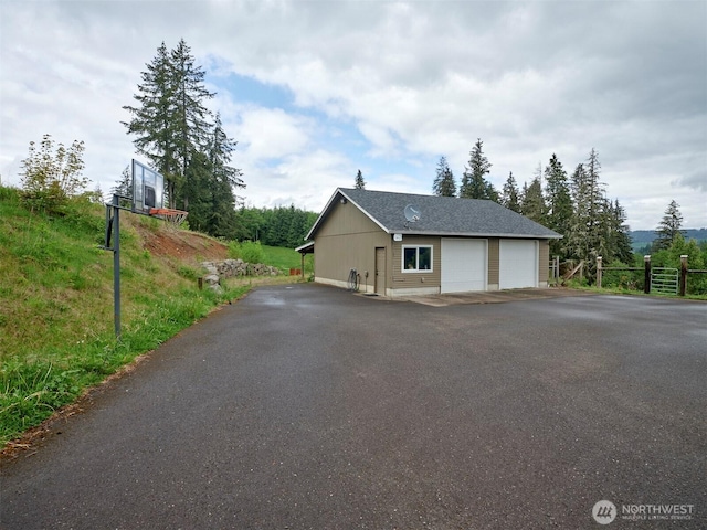 13708 401st Way, Amboy, WA 98601 - view of home's exterior featuring a detached garage, an outdoor structure, and fence