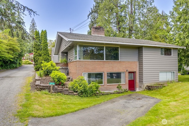 3822 Shelby Rd, Lynnwood, WA 98087 - view of front of house featuring a chimney, brick siding, and a front yard