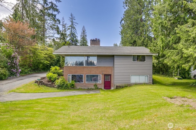 3822 Shelby Rd, Lynnwood, WA 98087 - view of front of home with a chimney, a front lawn, and brick siding