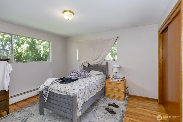 3822 Shelby Rd, Lynnwood, WA 98087 - bedroom featuring baseboard heating, light wood finished floors, and baseboards
