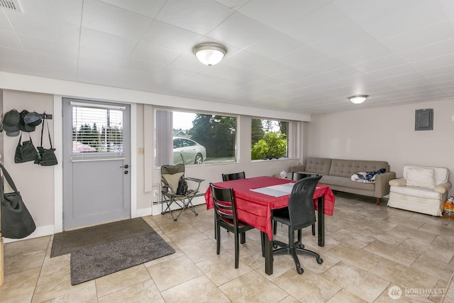 3822 Shelby Rd, Lynnwood, WA 98087 - dining space featuring plenty of natural light, baseboard heating, a drop ceiling, and baseboards