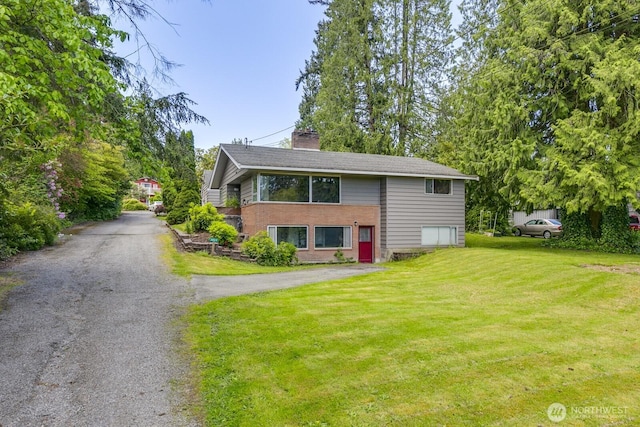 3822 Shelby Rd, Lynnwood, WA 98087 - view of front facade with a front lawn, a chimney, asphalt driveway, and brick siding