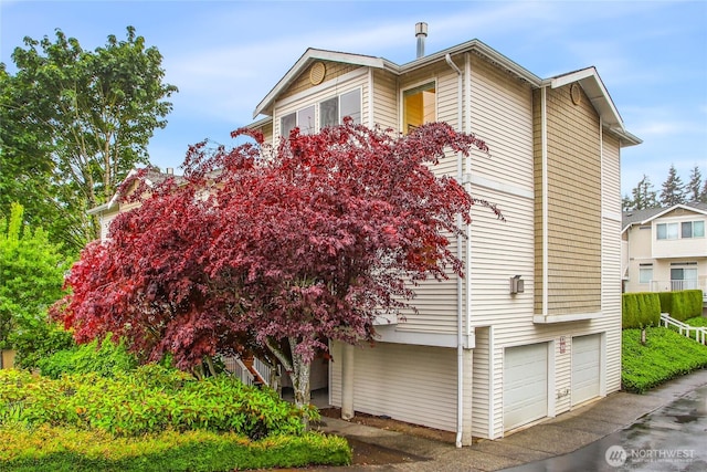4133 156th St SW Unit 7, Lynnwood, WA 98087 - view of home's exterior featuring an attached garage and driveway