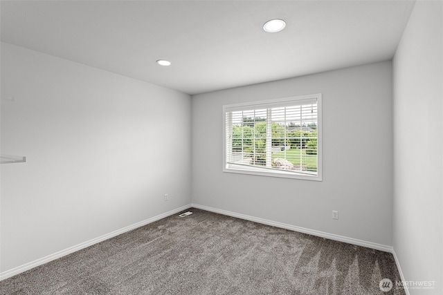 carpeted spare room featuring baseboards and recessed lighting