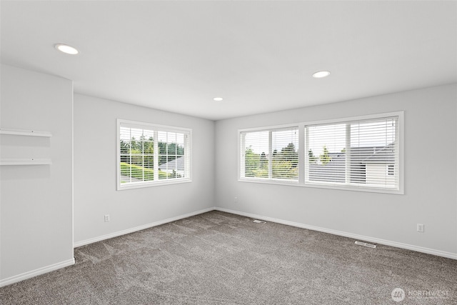 carpeted spare room featuring baseboards and recessed lighting