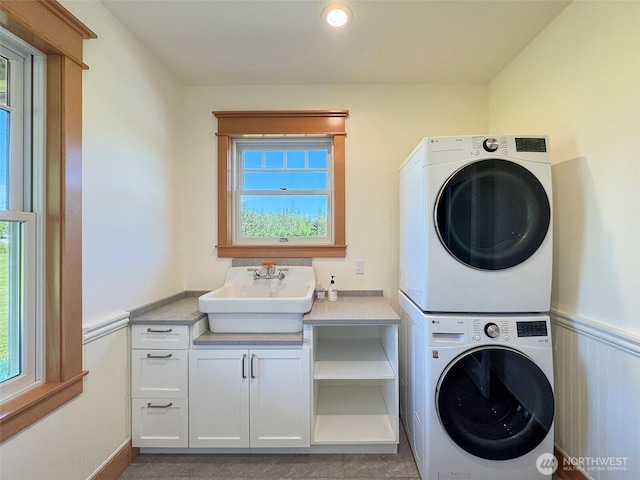 921 Chicken Coop Rd, Sequim, WA 98382 - laundry room with stacked washing machine and dryer and cabinet space