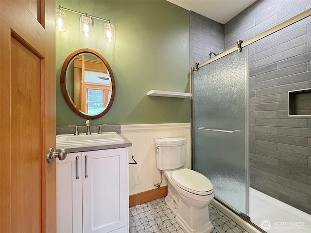 921 Chicken Coop Rd, Sequim, WA 98382 - full bath with a stall shower, toilet, vanity, and a wainscoted wall