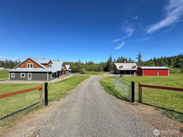 921 Chicken Coop Rd, Sequim, WA 98382 - view of dirt / gravel driveway with an outbuilding and a gated entry