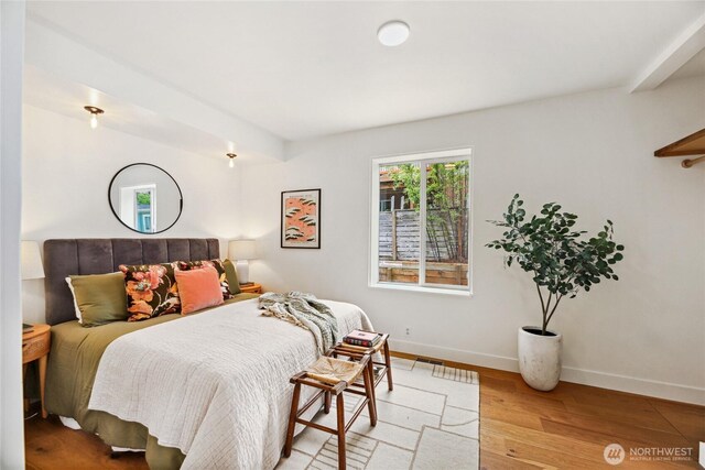 bedroom featuring light wood-style floors and baseboards