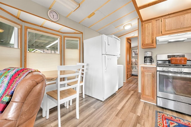 316 W Lake Samish Dr, Bellingham, WA 98229 - kitchen featuring gas stove, under cabinet range hood, freestanding refrigerator, light wood finished floors, and light countertops