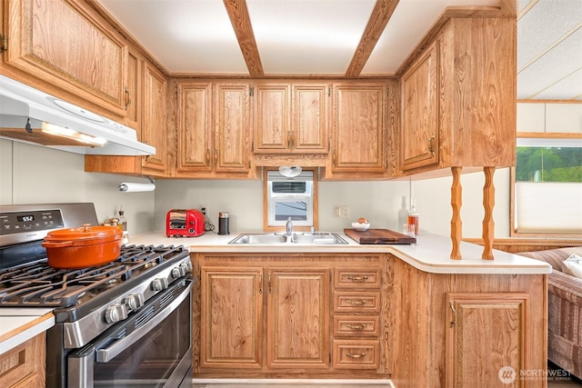 316 W Lake Samish Dr, Bellingham, WA 98229 - kitchen featuring gas range, a sink, under cabinet range hood, light countertops, and a peninsula