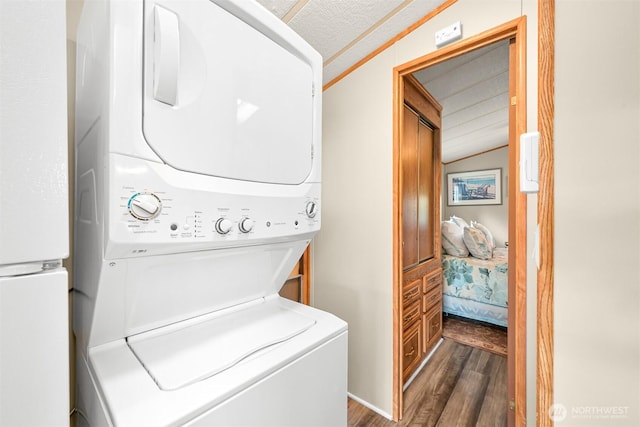316 W Lake Samish Dr, Bellingham, WA 98229 - clothes washing area with estacked washer and dryer and wood finished floors