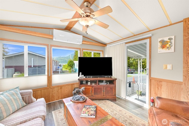 316 W Lake Samish Dr, Bellingham, WA 98229 - living area with a wall mounted air conditioner, lofted ceiling, plenty of natural light, wainscoting, and wood finished floors