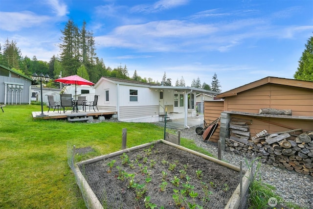 316 W Lake Samish Dr, Bellingham, WA 98229 - rear view of property with a garden, a deck, a yard, and outdoor dining space
